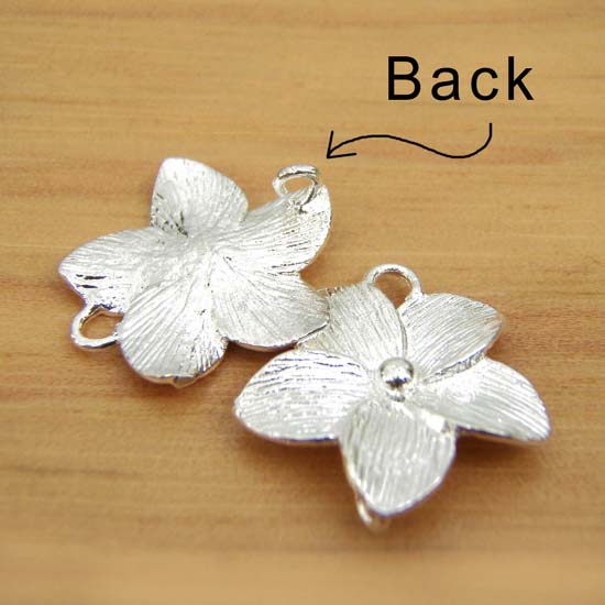 shows the back of silver flower connectors
