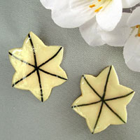 lacquered paper cream six-petal clip on earrings
