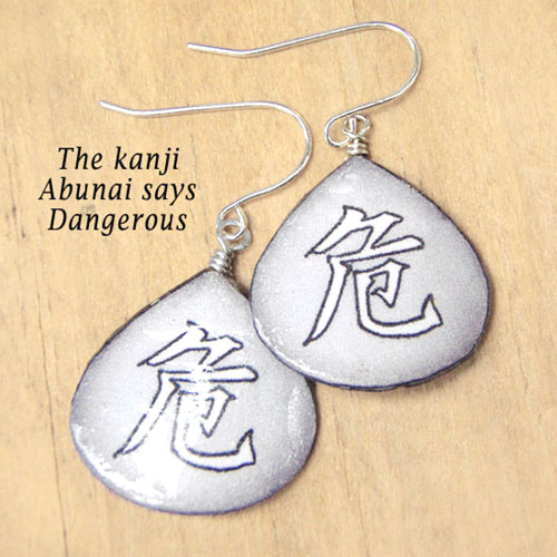 gray lacquered paper kanji earrings that say Abunai, or Dangerous