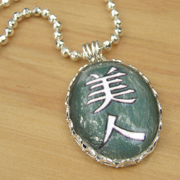 Paper Jewels kanji necklace that says Bijin, or Beautiful Woman