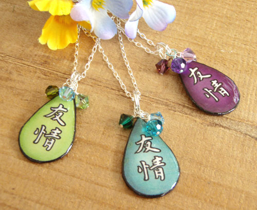 lacquered paper Japanese kanji friendship 
                necklace - shown in peridot, turquoise and purple. With Swarovski crystal accents and sterling silver chain