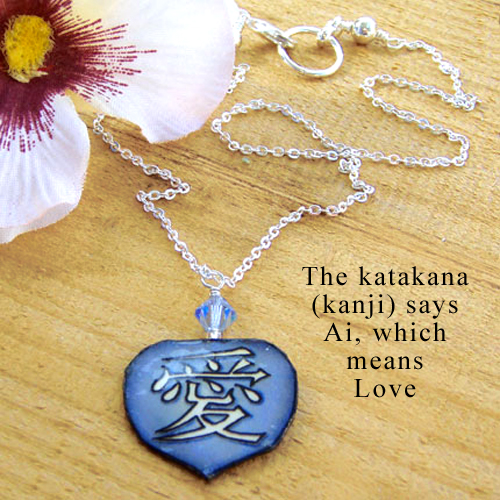 lacquered paper blue necklace with the japanese kanji that says Love