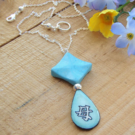 lacquered paper pendant with the japanese kanji that says Mother...with a turquoise howlite diamond pendant bead, and silver plated chain