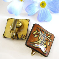 deep tan, offwhite and black lacquered paper clip on earrings with the Japanese kanji that says Love