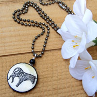black and white lacquered paper zebra pendant on an antiqued silver plated brass ball chain 